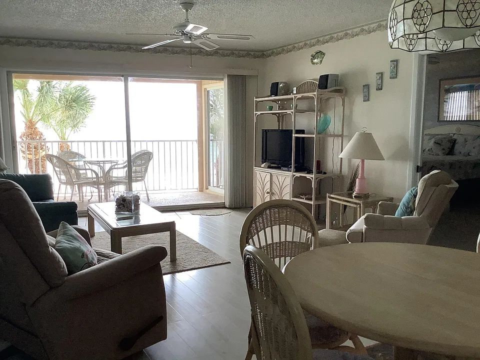 Dining room and living room with a Gulf-front view