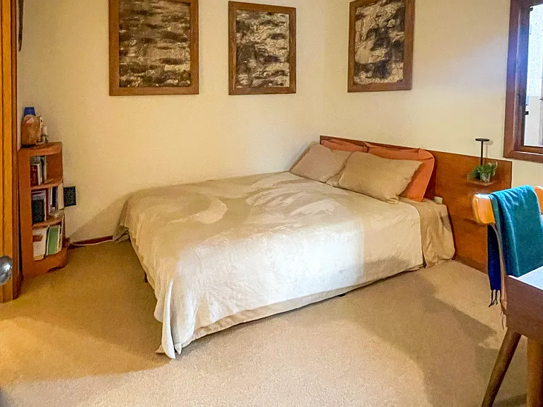 Cozy bedroom with queen-size bed and writing desk