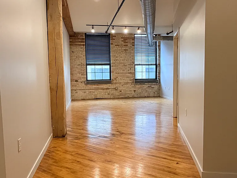 Living Area (Photos of similar unit with same floor plan. Unit 211 will have higher exposed beam ceilings. Colors, finishes, and fixtures may vary)