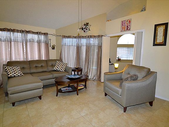 Comfy family room with updated flooring, wall of windows and french doors that lead to the backyard.