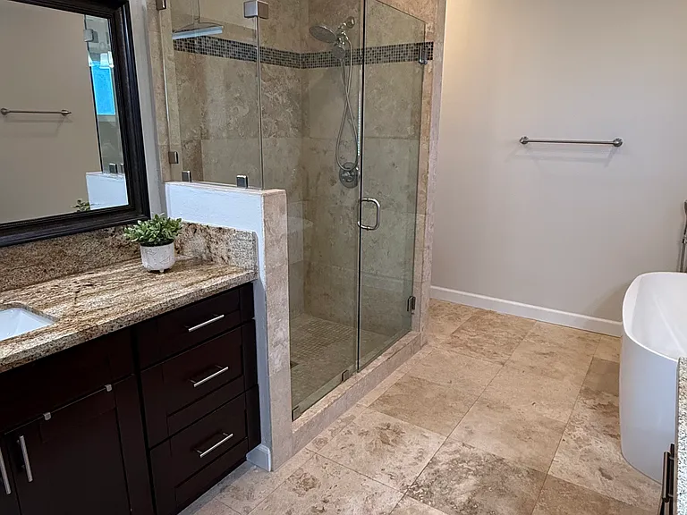 Primary bathroom with bathtub, shower and his-and-hers sinks