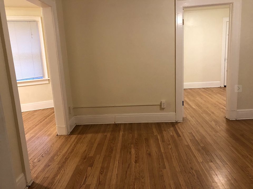 Looking from the entry through the living room towards the bedroom on the right. Dinning Room is on the left.