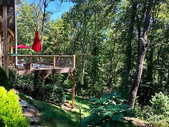 LOWER LEVEL DECK IS HIGH ENOUGH OFF THE GROUND ENJOY THE BREEZES OF THE TREEHOUSE AND WOODED VIEWS!