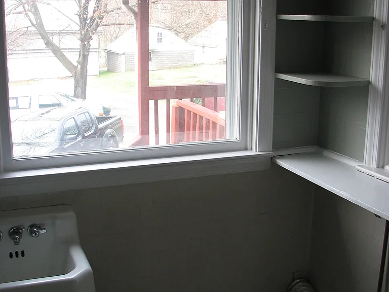 Laundry area (behind bookcase in kitchen)