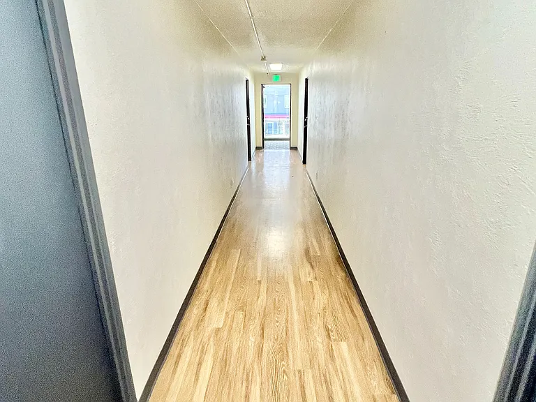 Experience the elegance of this well-lit hallway, perfect for a welcoming entrance.