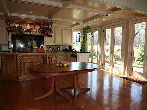 kitchen surrounded by french doors, open to horse pastures, lake & mt. views