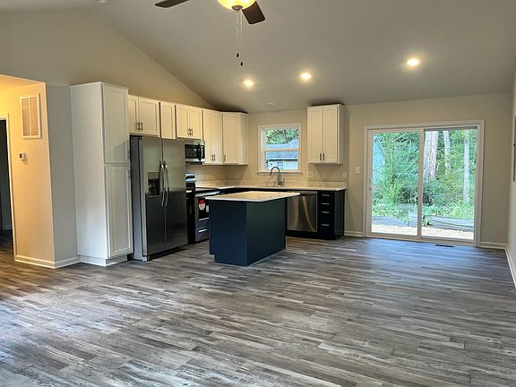 Another view of the living space and kitchen. Ample storage, including large entrance closet at front door (not shown).