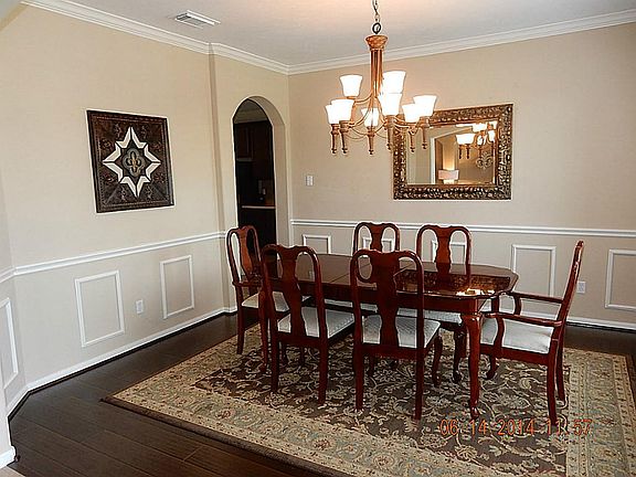 Wood floors enhance the appeal of the formal dining room.
