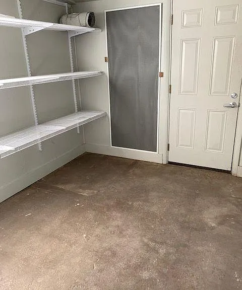 another view of large storage room, door to back yard.