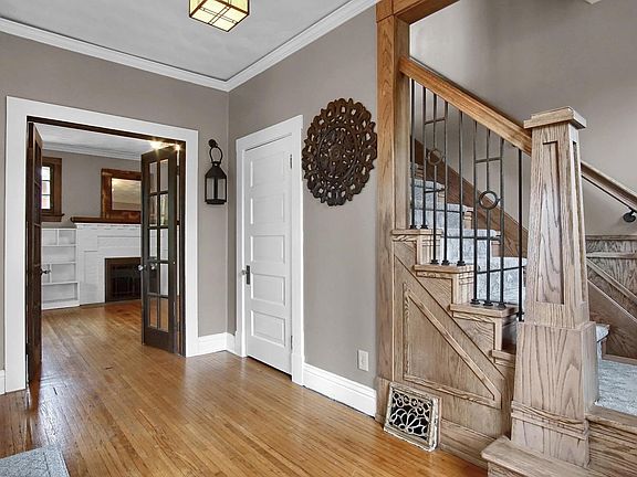 Foyer view with French doors into Living Room and New custom wood staircase