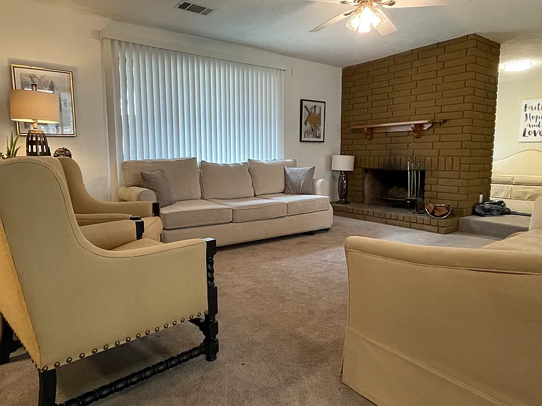 View towards formal dining room and living room with working fireplace