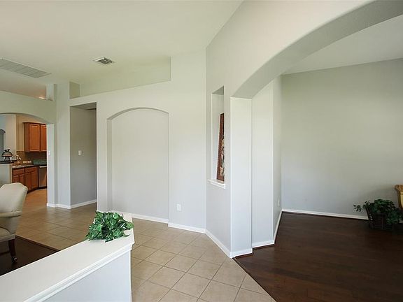 Foyer is tile flaked by new wood floors in living room/study.