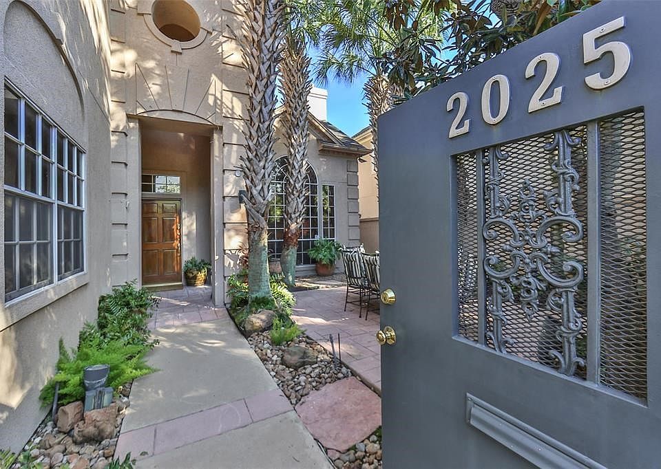 The private gated entrance to the front courtyard welcomes you and your guests to this lusciously landscaped oasis that is perfect for entertaining.
