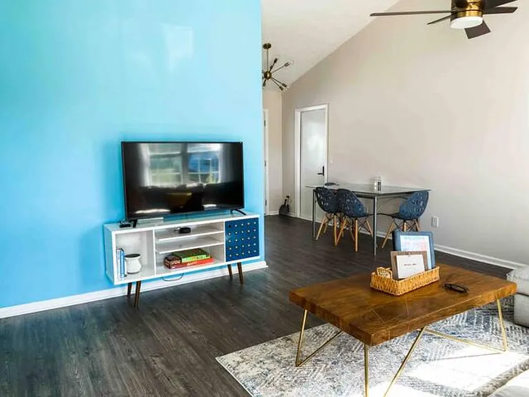 Living room accent wall features a gorgeous pop of color