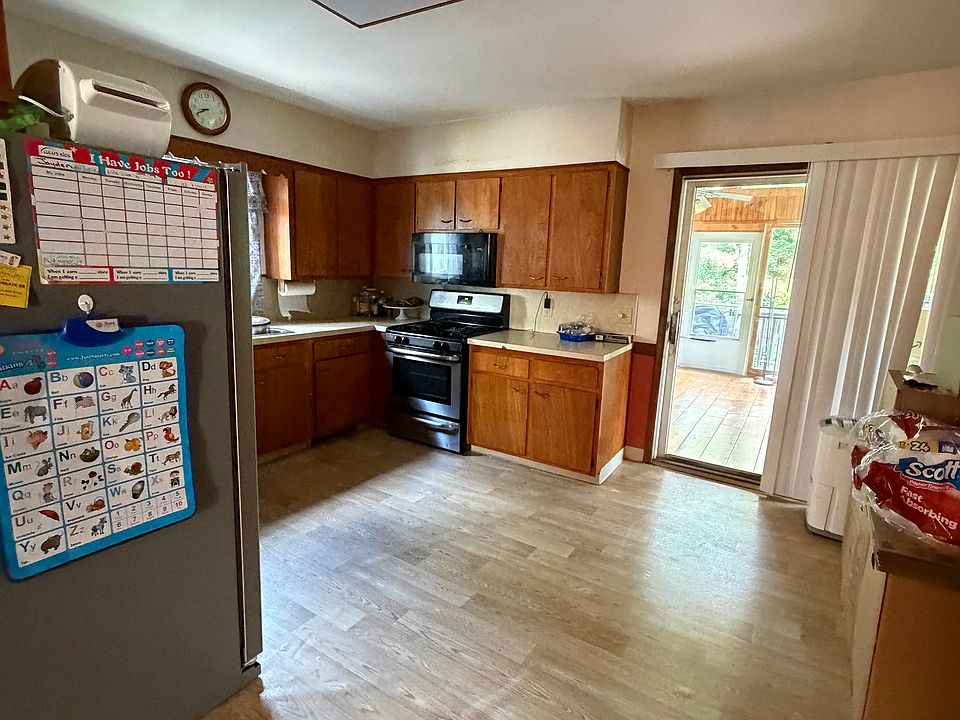 Kitchen with sliding glass door to year round porch overlooking huge backyard