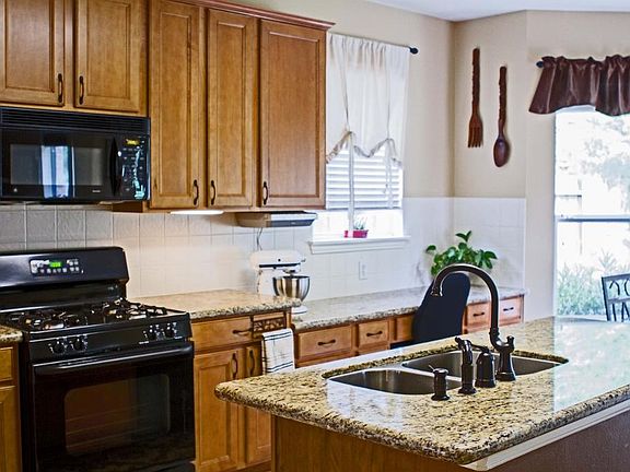 Additional view of the wonderful large island kitchen that also features large cabinets with under cabinet lighting and all hardware replaced