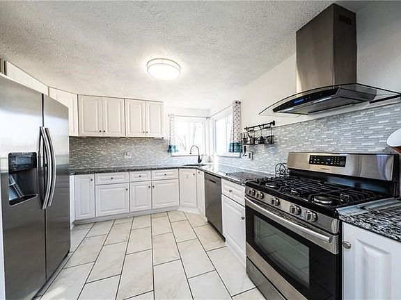 THIS KITCHEN IS EVERYTHING! The sink was moved during the renovation to give you a view while you are washing dishes or loading 