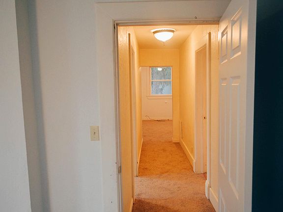 View from living room, down the hallway leading to the bathroom and two bedrooms.