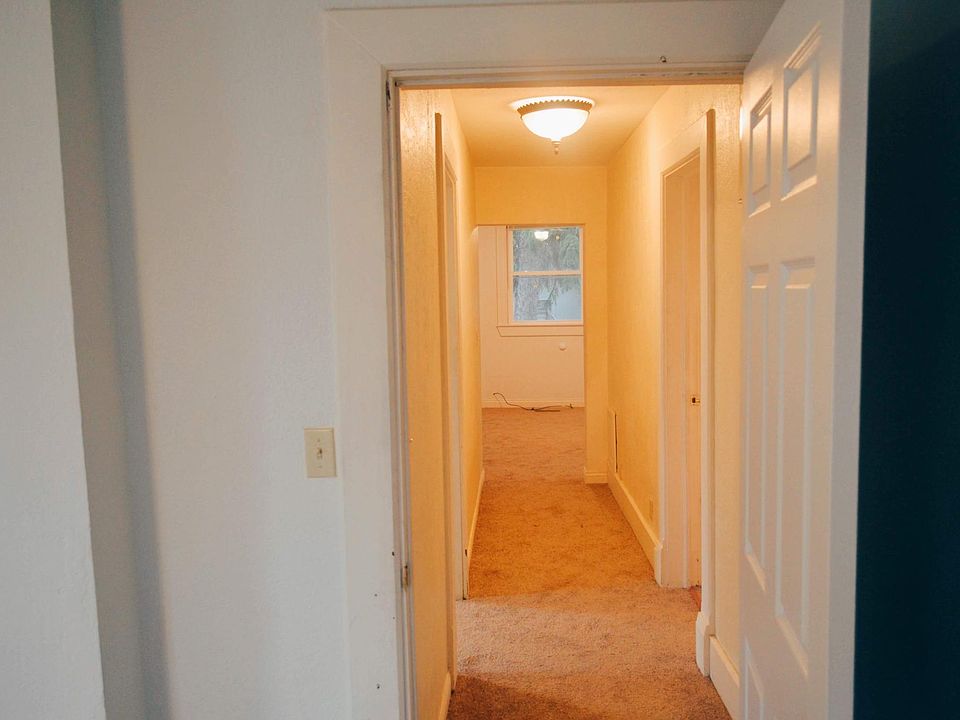 View from living room, down the hallway leading to the bathroom and two bedrooms.