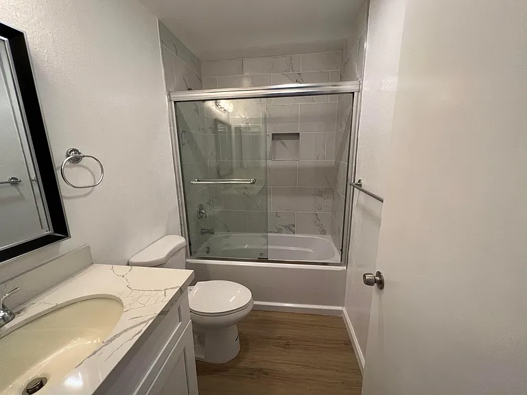 Bathroom with newly renovated bathtub/shower, toilet, and sink area!