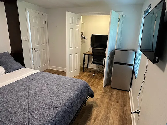 Master Queen size bedroom view of the closet setup with working space for remote work. Small refrigerator is optional.