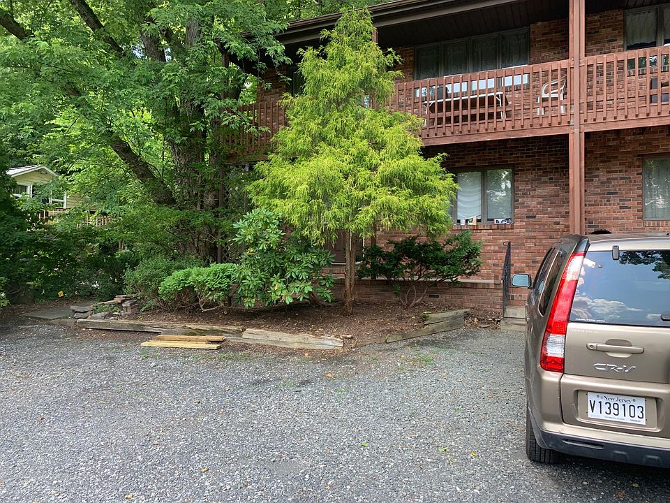 The townhouse is on the end of a three-unit building, at 16 Risler Street in Stockton, NJ. There is a large gravel off-street parking area to the left that can accommodate four or more vehicles.