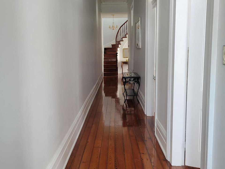 Long hallway with original hardwood floors