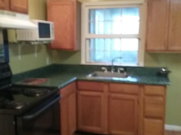 Fully equipped kitchen stove, refrigerator , microwave chestnut stained wood cabinets. Adjoining Laundry Room