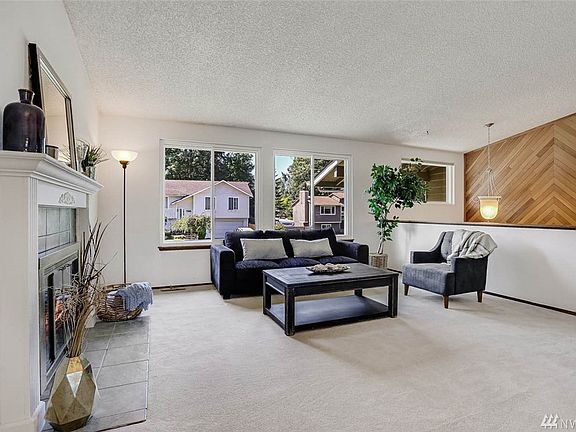 Enjoy a cozy wood burning fireplace with tile surround and white millwork.