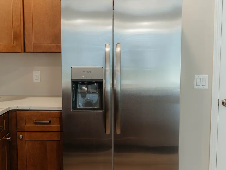 Brand new side by side fridge/freezer with ice and water in the door.