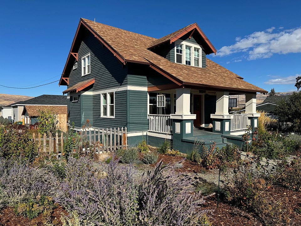 Exterior of the house with large front porch and beautiful landscaping