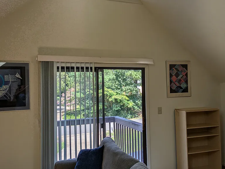 Great room -- high ceiling, leaded glass, two couches and tv