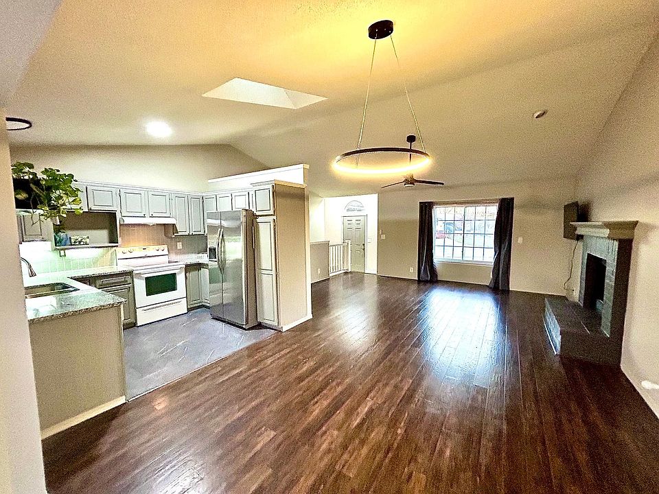 Dining, kitchen and living room with fireplace and new granite, lighting & fresh paint