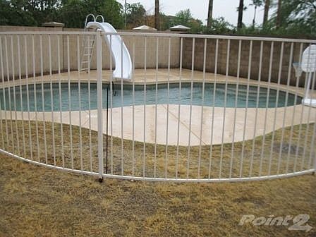 Back yard fenced pool with slide