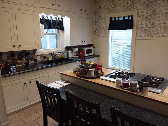 Another view of kitchen. Bar off island Dishwasher in end of island.