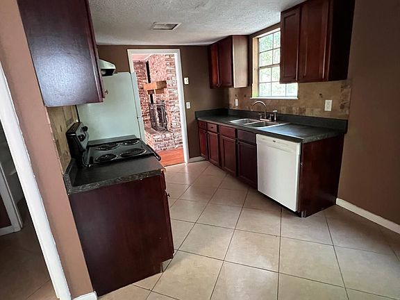 Kitchen showing new D/W and refrigerator