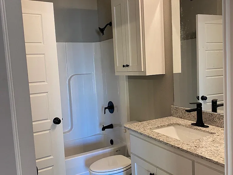 Bedroom #2's Bathroom. Door to bedroom and door to hallway for guests.