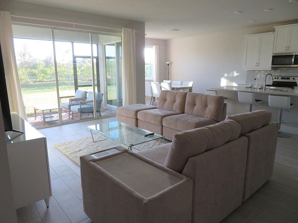 Open concept living room/kitchen/dining space with 5 sliding glass doors (3 from the living room and 2 from the dining room). Lots of natural light in the living area.