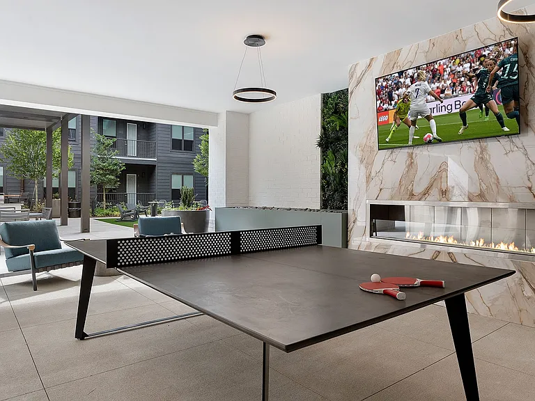 Outdoor passthrough with ping-pong, wall Scrabble, TVs and ample seating
