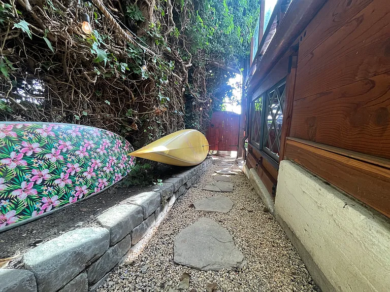 entry walkway and access for surfboards and paddleboards, with mature Ivy entryway, privacy