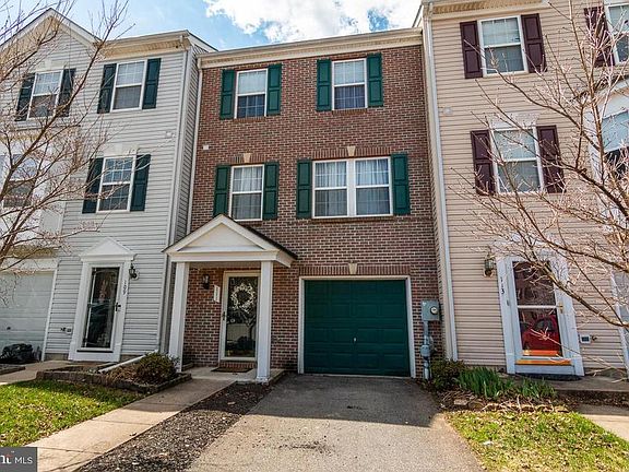 Brick front garage townhome with driveway