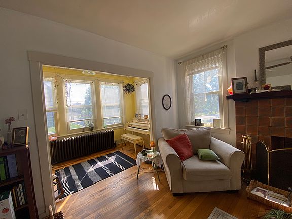 Hardwood floor, original fireplace sunroom and living room