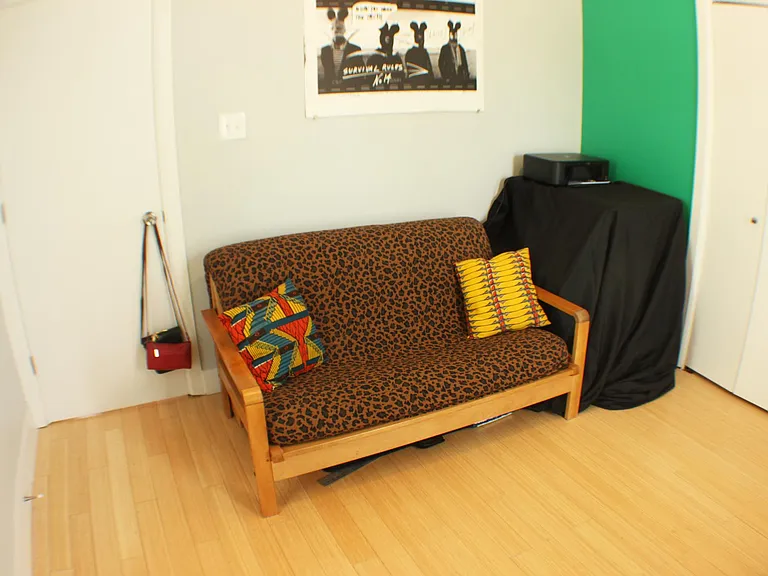 The second bedroom. The green walls will be repainted light gray before the lease begins. The second bedroom features a spacious closet.
