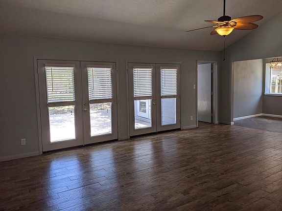 Looking over the enormous Living Room toward the Kitchen and Mother-in-Law Suite. Dual French Doors lead to the backyard.