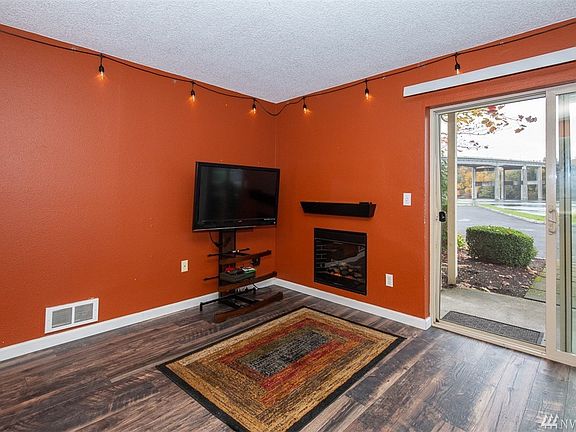Vermont Castings electric fireplace with mantle in living room and easy care laminate floors.