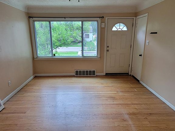 Living room with beautiful hardwood floors and nice big window for lots of light