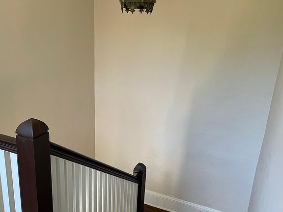 Front entry stairway with antique lighting fixture.