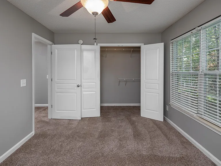 Bedroom with carpet and generous closet space