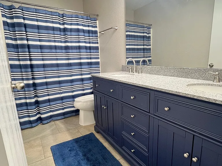 Guest bath with new double-sink vanity with granite counters.