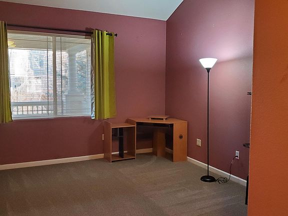 Master Bedroom with vaulted ceiling overlooks balcony and includes walk in closet